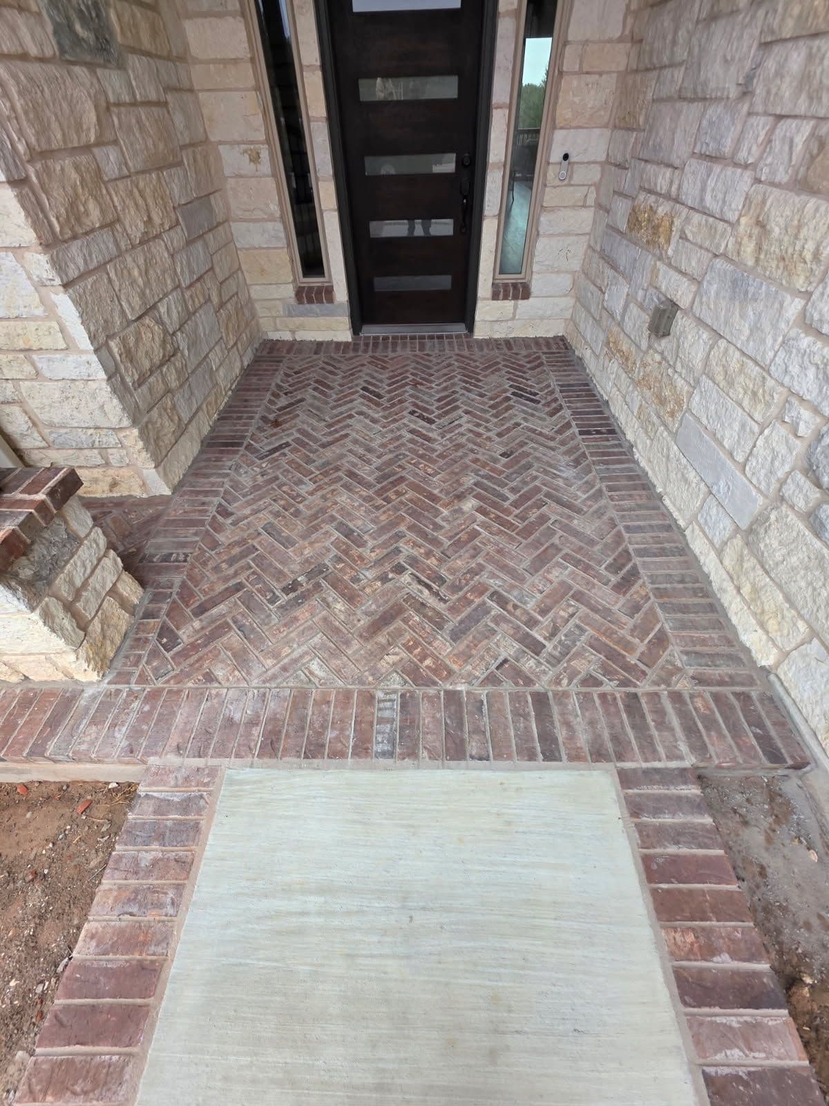 Stunning Brick Porch and Concrete Sidewalk Installation image
